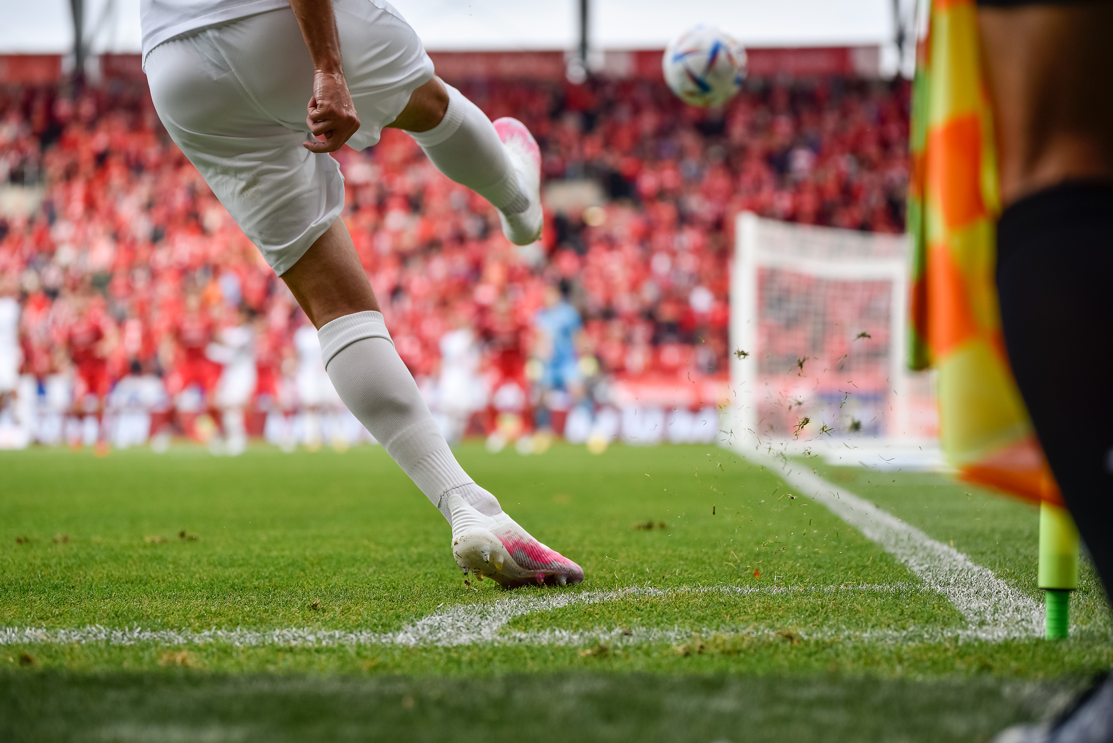 Footballer taking a corner. Stats tracked for performance trends. STATZO app is a grassroots stats app